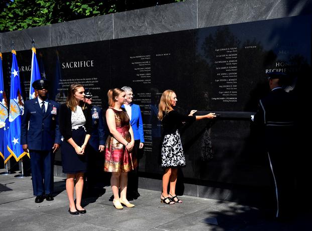 Valerie Nessel, spouse of U.S. Air Force Tech. Sgt. John Chapman, and his daughters Brianna and Madison Chapman, unveil his name during a ceremony at the Air Force Memorial, in Arlington, Va., Aug. 24, 2018. Sergeant Chapman was posthumously awarded the Medal of Honor for actions on Takur Ghar mountain in Afghanistan on March 4, 2002. (Rusty Frank/Air Force)