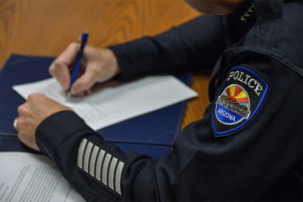 U.S. Air Force Col. Robert Sylvester, 56th Mission Support Group commander, signs an educational opportunities memorandum with the West Maricopa Education Center Aug. 14, 2018. (U.S. Air Force photo by Tech. Sgt. Clinton Atkins)