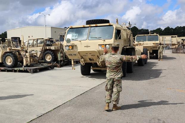 3rd Expeditionary Sustainment Command Soldier lines up vehicle in preparation for Hurricane Florence at Fort Bragg, North Carolina, September 12, 2018. (U.S. Army/Staff Sgt. Terrance Payton)