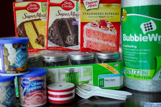 Start with a pile of cake and care package supplies. (Military.com)