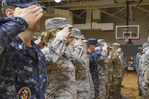 Sailors, Airmen, and Soldiers salute in formation during the closing ceremony June 5, 2018, of an Innovative Readiness Training in Thomasville, Alabama. (U.S. Air National Guard/Airman Cameron Lewis)
