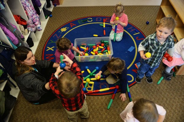Crystal Emmons, a program technician at the McRaven Child Development Center, plays with the children in her classroom at Ellsworth Air Force Base, S.D., Feb. 6, 2018. (U.S. Air Force photo/Thomas Karol)