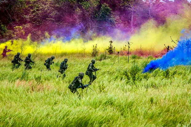 U.S. Marines and Malaysian troops use smoke to obscure their movements during an exercise in Tanduo Beach, Malaysia, Aug. 17, 2018, as part of Cooperation Afloat Readiness and Training 2018. (Marine Corps photo by Lance Cpl. A. J. Van Fredenberg)