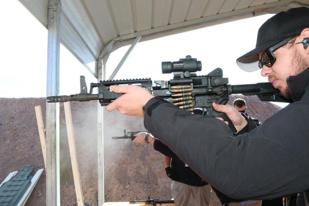Mike Ruggles from FightLite Industries showing of the Mission Configurable Rifle, MCO, upper that will fit on any AR lower receiver, at SHOT Show 2019. (Military.com/Matthew Cox)