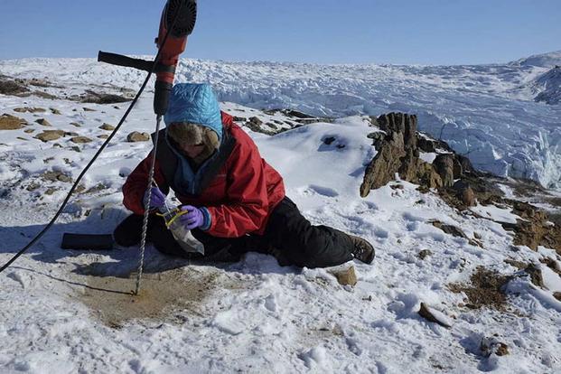 Dr. Lisa Pratt collects a sample from a winter drilling expedition at the edge of the Greenland ice sheet in 2014. Photo courtesy of Dr. Lisa Pratt