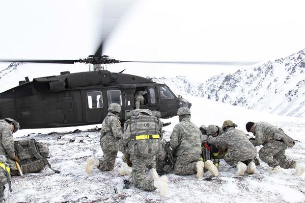 Guardsmen with the 207th Engineer Utilities Detachment, with UH-60 Black Hawk helicopter transportation support from 1st Battalion, 207th Aviation Regiment, participate in Arctic skills training in Snowhawk Valley near Joint Base Elmendorf-Richardson, Alaska, on Feb. 9, 2019. The Army has contracted with Raytheon Co. to supply new aviation radios. (U.S. Army National Guard photo by Spc. Michael Risinger)