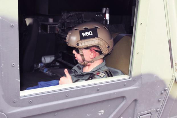 Drake Quibodeaux, 8, from Vinton, La., gives a thumbs up before heading out for a ride with Brig. Gen. Patrick D. Frank, commander, Joint Readiness Training Center and Fort Polk during a visit to the installation March 1. Quibodeaux, who suffers from a brain tumor, and his family were invited to Fort Polk where Drake was made an honorary soldier. (US Army/Chuck Cannon)