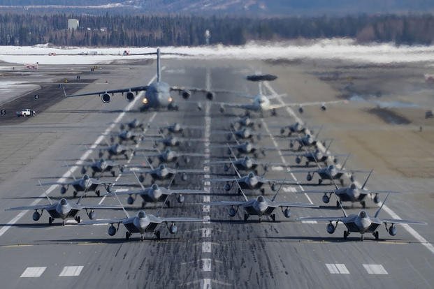F-22 Raptors from the 3rd Wing and 477th Fighter Group participate in a close formation taxi with an E-3 Sentry and a C-17 Globemaster III, known as an Elephant Walk, March 26, 2019, during a Polar Force exercise at Joint Base Elmendorf-Richardson, Alaska. (U.S. Air Force photo/Justin Connaher)