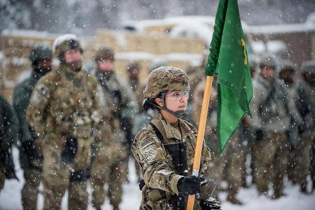 Army Pfc. Keylin Perez stands in front of the formation bearing the unit guidon during a field training exercise at Fort Meade, Md., Jan. 13, 2019. Perez is assigned to the 200th Military Police Command’s Headquarters Company. (U.S. Army/Army Master Sgt. Michel Sauret)