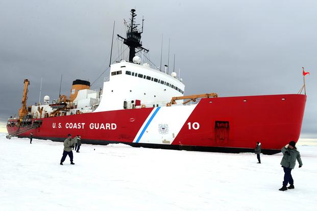 Master Chief Petty Officer Gregory Zerfass and Petty Officer 1st Class Allen Birt, members of Coast Guard Cutter Polar Star's navigation division, play catch during ice liberty is the Ross Sea, Jan. 9, 2015. (U.S. Coast Guard/Petty Officer 1st Class George Degener)