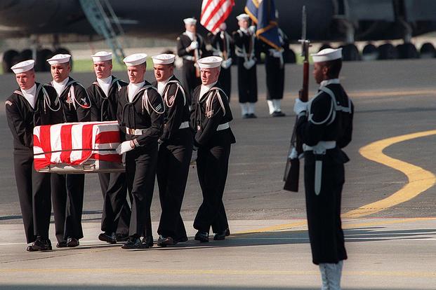 Navy pallbearers carry the remains of one of the 47 crew members killed in an explosion aboard the battleship USS IOWA (BB-61). (Photo: US Navy)