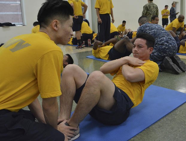A Reserve sailor performs curl-ups during the physical readiness test in the drill hall at Navy Operational Support Center (NOSC) Los Angeles. (Pyoung K. Yi/Navy)