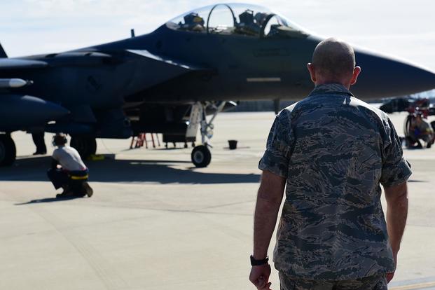 Gen. Mike Holmes, commander of Air Combat Command, watches Airmen from the 4th Aircraft Maintenance Squadron load inert weapons onto an F-15E Strike Eagle during training, Feb. 26, 2019, at Seymour Johnson Air Force Base, North Carolina. (U.S. Air Force/Senior Airman Kenneth Boyton)