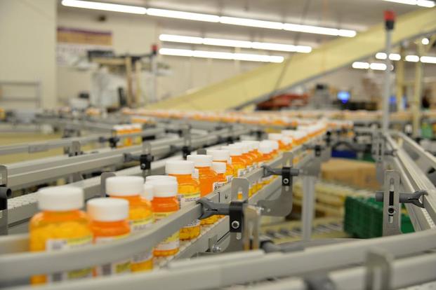 Bottles of prescription medication move along a conveyor belt at the Department of Veterans Affairs’ Consolidated Mail Outpatient Pharmacy facility in North Charleston, South Carolina. (VA Photo)