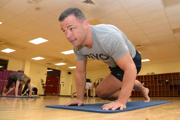 Air Force Maj. Michael Bliss, 703d Aircraft Maintenance Squadron commander, leads a PiYo class at the JBER-Elmendorf fitness center Feb. 4, 2015. (U.S. Air Force/Staff Sgt. Wes Wright)