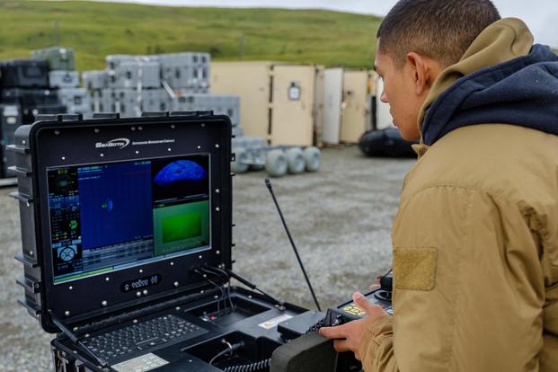 Electronics Technician Third Class John Swan controls the Seabotix Vectored Little Benthic Vehicle.