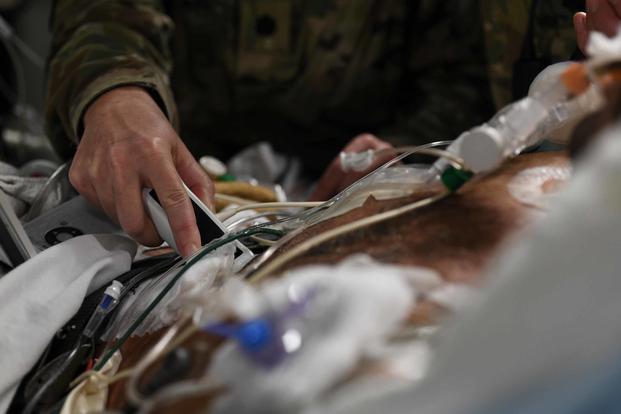 Lt. Col. Valerie Sams, 59th Medical Wing trauma surgeon, performs an ultrasound to monitor a patient during a direct flight from Bagram Airfield, Afghanistan, to San Antonio on Aug. 18, 2019. This unique aerial mission providing around-the-clock patient care was refueled twice in-air, supported by multiple pilots, aircrew and joint service teams of medics working in shifts to maintain the highest level of care possible. (U.S. Air Force photo by Airman 1st Class Ryan Mancuso)