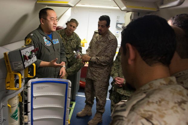 Lt. Fan Yang, left, a tactical coordinator assigned to Patrol Squadron (VP) 5, demonstrates the systems onboard a P-8A Poseidon aircraft to members of the Royal Saudi Naval Forces. (U.S. Navy photo/Jakoeb Vandahlen)