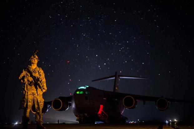 A U.S. Air Force Phoenix Raven team member, assigned to the 816th Expeditionary Airlift Squadron, guards a C-17 Globemaster III at Forward Operating Base Shank, Afghanistan, on Feb. 8, 2018. Phoenix Ravens are an elite group of U.S. Air Force Security Forces personnel charged with ensuring the security of high-value assets and aircraft in hostile and high-risk locations. (Gregory Brook/U.S. Air Force)