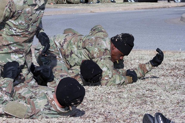 Spc. Jimmy Legree (with mouthpiece) practices combatives Dec. 11, 2019, along with other trainees at Fort Sill, Okla. Legree, who played two seasons for the Arizona Cardinals, is in his second week of Basic Combat Training with D Battery, 1st Battalion, 19th Field Artillery. (U.S. Army photo)