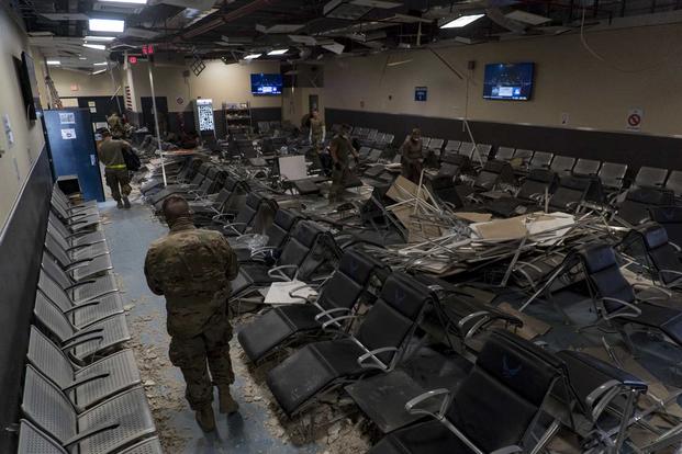 U.S. Air Force Airmen from the 405th Expeditionary Support Squadron work together to clear debris inside the passenger terminal the day after a Taliban-led attack at Bagram Airfield, Afghanistan, Dec. 12, 2019 (U.S. Air Force/Airman 1st Class Brandon Cribelar)
