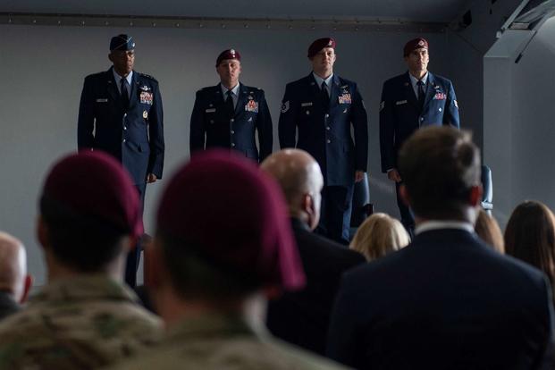 Gen. CQ Brown Jr., Pacific Air Forces commander, Lt. Col. Douglas Holliday, 58th Rescue Squadron commander, Tech. Sgt. Gavin Fisher, 350th Special Warfare Training Squadron pararescueman, and Staff Sgt. Daniel Swensen, 58th Rescue Squadron pararescueman, stand at attention during a ceremony at Nellis Air Force Base, Nevada, Dec. 13, 2019. (U.S. Air Force/Airman 1st Class Bryan Guthrie)