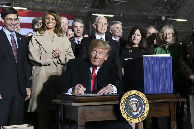 President Donald Trump signs S.1790, the National Defense Authorization Act for Fiscal Year 2020 as senior leaders look on, Friday, Dec. 20, 2019 At Joint Base Andrews.. (U.S. Air Force/Airman 1st Class Spencer Slocum)