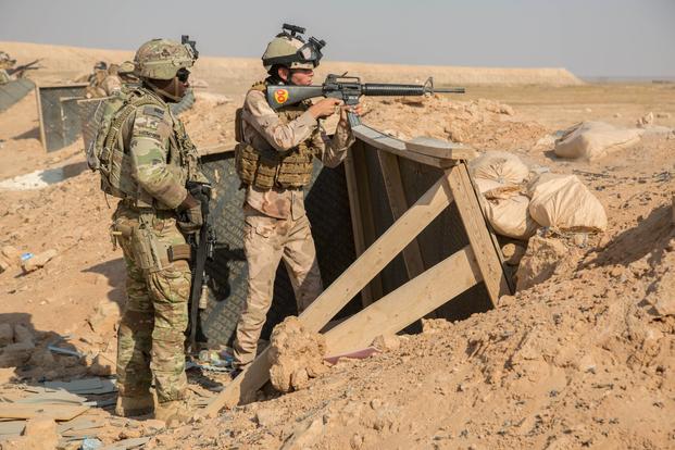 Iraqi Commandos provide cover fire during an air assault exercise at Al Asad Air Base, Iraq