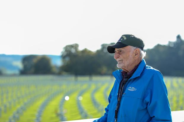 A WWII veteran looks out over the rows of headstones at the Henri-Chapelle American Cemetery and Memorial in Belgium.