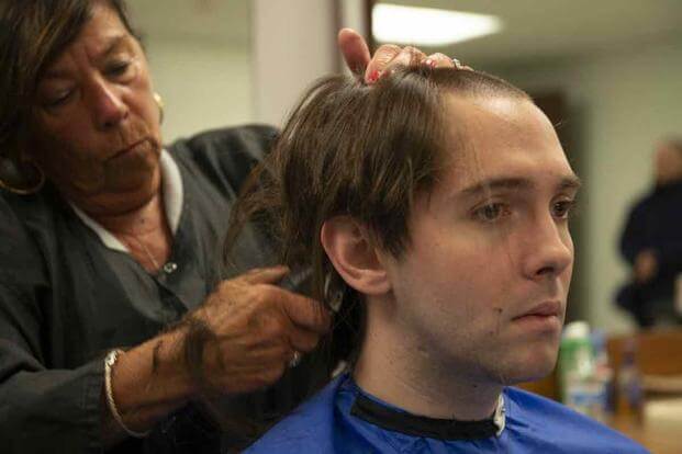 A hair dresser at Coast Guard Training Center Cape May, gives recruits haircuts at Dempsey Hall.