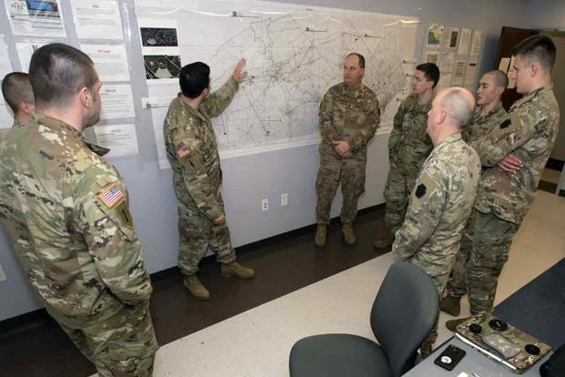 Capt. Richard Auletta briefs his staff before their shift change in the Joint Emergency Operation Command Horsham Air Guard Station, Pennsylvania. 