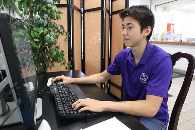 teen working on computer
