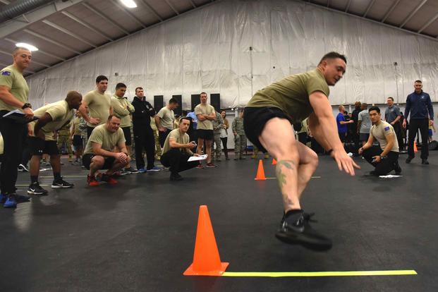 Master Sgt. Kyle Anderson runs between two cones during a speed, strength and agility demonstration.