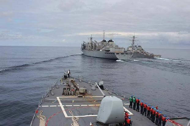 The Arleigh Burke-class guided-missile destroyer Donald Cook approaches alongside the USNS SUPPLY and USS Porter for a connected replenishment