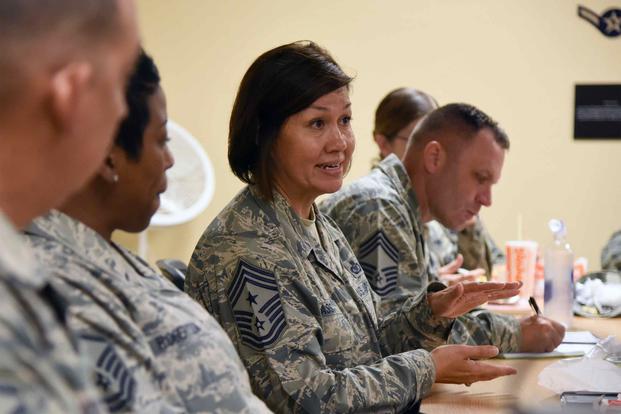 Chief Master Sgt. JoAnne Bass engages in conversation with Airmen at the Keesler Professional Development Center.
