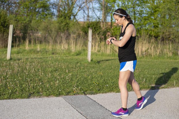 woman preparing to run starting watch