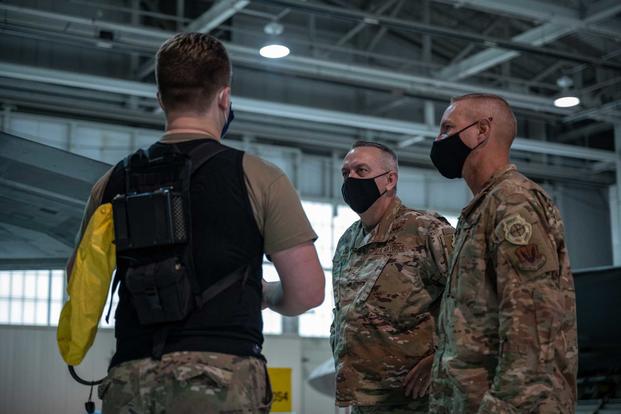 An airman shares his experience withthe personal cooling suit.