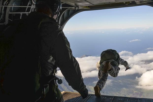 A U.S. soldier assigned to Special Operations Command Pacific (SOCPAC) jumps from a CH-47 Chinook helicopter
