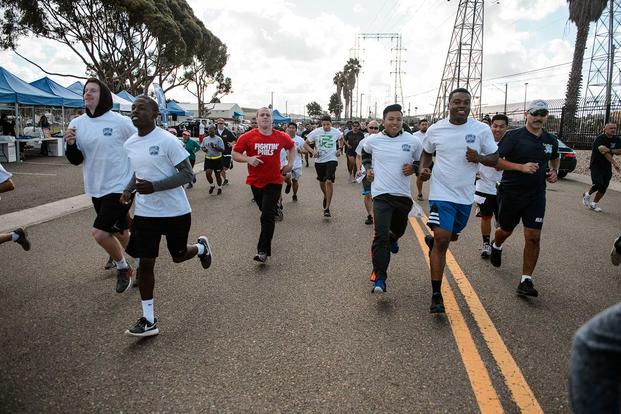 Service members, family and friends take part in a MWR Veterans Day run or walk.