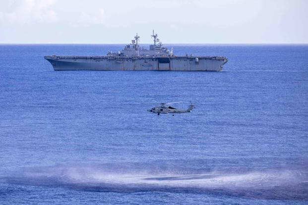 An MH-60R Seahawk Helicopter approaches the USS Wasp