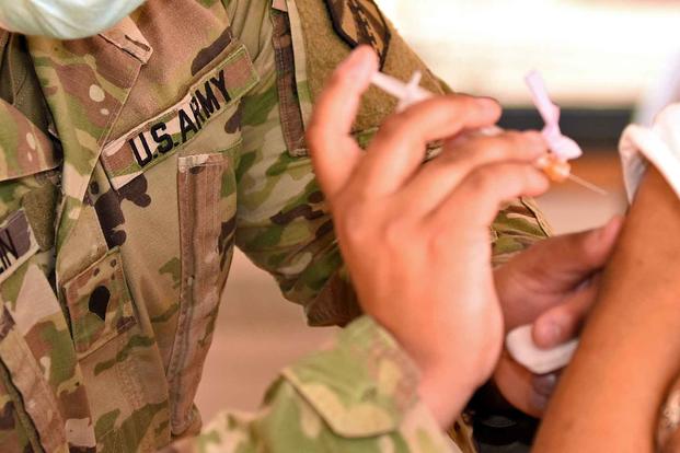 U.S. Army soldier with the Michigan National Guard administers the COVID-19 vaccinations