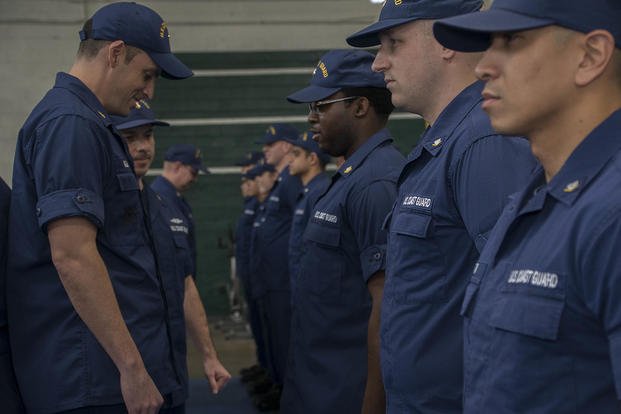 Lieutenant commander inspects Coast Guard uniforms