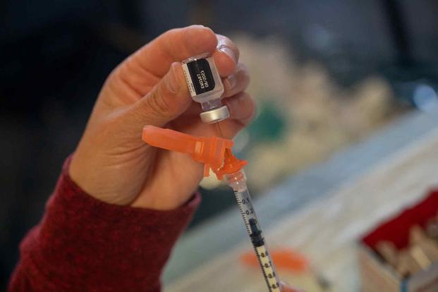 A medic pulls a vaccine at Patch Barracks near Stuttgart.