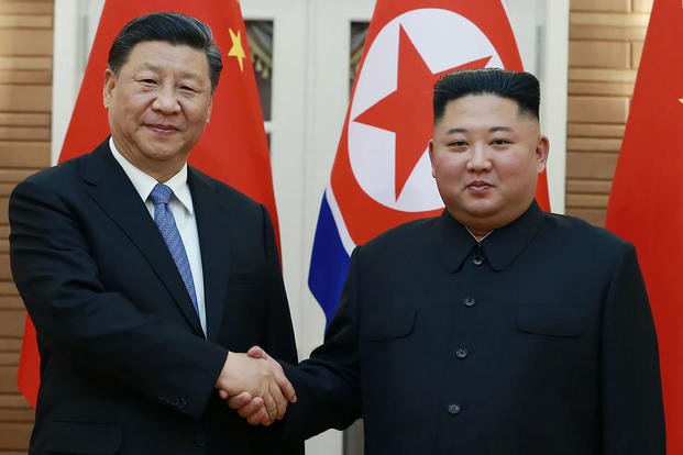 North Korean leader Kim Jong Un, right, poses with Chinese President Xi Jinping 