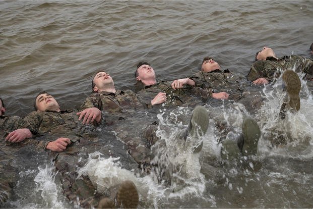 Combat rescue officer candidates perform flutter-kicks.