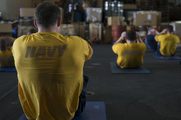 Sailors hold group physical training.