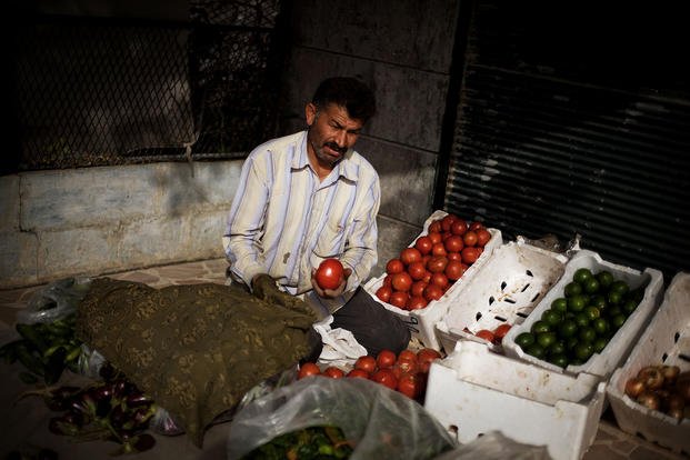 A vegetable vendor is on outskirts of Aleppo, Syria.