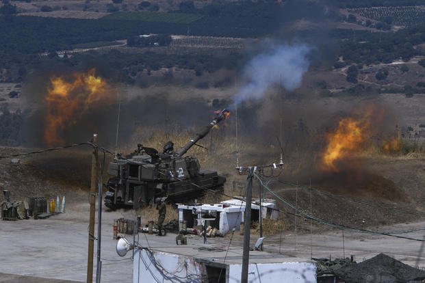 Israeli forces fire artillery from their position on the border with Lebanon.