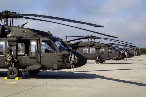Flight line view of U.S. Army UH-60L Black Hawk helicopters.