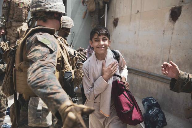Boy is processed during evacuation at Hamid Karzai International Airport